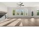 Living room features a modern fireplace with wooden mantel and lots of windows to bring in natural light at 1005 Coleman Place Dr, Roswell, GA 30075
