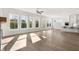 Bright, open-concept living area featuring hardwood floors, lots of windows, and seamless flow to the kitchen at 1005 Coleman Place Dr, Roswell, GA 30075