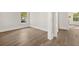 Bright living room with light hardwood floors and large windows offering neighborhood view at 1005 Coleman Place Dr, Roswell, GA 30075
