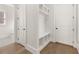 Mudroom with custom built-in storage cubbies, bench, and access to a bathroom and exterior door at 1005 Coleman Place Dr, Roswell, GA 30075