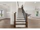 Elegant staircase with wood and iron railings leads to the upper level of this beautiful home at 1005 Coleman Place Dr, Roswell, GA 30075