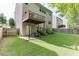 Spacious backyard with well-maintained lawn, a patio, and partial fencing for privacy at 2365 Valley Mill Dr, Buford, GA 30519