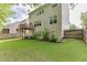 Large, grassy backyard featuring mature landscaping, a patio, and a partial fence at 2365 Valley Mill Dr, Buford, GA 30519