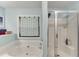 Bathroom featuring a soaking tub next to a window and a glass-enclosed shower at 2365 Valley Mill Dr, Buford, GA 30519