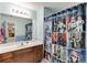 Bathroom featuring wood cabinets, a large mirror, and a Star Wars themed shower curtain at 2365 Valley Mill Dr, Buford, GA 30519