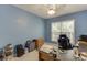 Cozy bedroom featuring blue walls, a ceiling fan, and a large window providing natural light at 2365 Valley Mill Dr, Buford, GA 30519