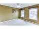 Neutral bedroom with two windows providing natural light and a ceiling fan at 2365 Valley Mill Dr, Buford, GA 30519