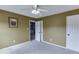 Bedroom view showcasing a ceiling fan, closet doors, and entrance to another room at 2365 Valley Mill Dr, Buford, GA 30519