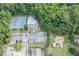 Aerial view of a community pool, tennis courts, parking and playground nestled in a lush green neighborhood at 2365 Valley Mill Dr, Buford, GA 30519