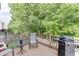 Outdoor deck with a grill and seating area, ideal for enjoying the natural scenery at 2365 Valley Mill Dr, Buford, GA 30519