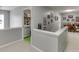 Upstairs hallway with laundry area and picture frames on the wall at 2365 Valley Mill Dr, Buford, GA 30519