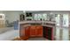 Open kitchen with breakfast bar, wood cabinets and a dishwasher at 2365 Valley Mill Dr, Buford, GA 30519
