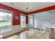 Formal room with two windows, a view of the front entrance, hardwood floors and red accent wall at 2365 Valley Mill Dr, Buford, GA 30519