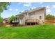 Spacious backyard featuring a large deck, covered porch, lush lawn, and fenced perimeter at 4004 Charrwood Trce, Marietta, GA 30062