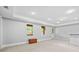 Spacious finished basement with neutral walls and carpet, natural light, and door access at 4004 Charrwood Trce, Marietta, GA 30062