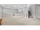 Spacious finished basement with neutral walls and carpet, bar area, and staircase at 4004 Charrwood Trce, Marietta, GA 30062