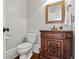 Elegant half bathroom featuring a carved wood vanity and ornate mirror at 4004 Charrwood Trce, Marietta, GA 30062