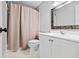 Bathroom featuring a modern vanity, mosaic mirror, toilet, and shower with beige curtain at 4004 Charrwood Trce, Marietta, GA 30062