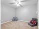 Cozy carpeted bedroom featuring a ceiling fan, chair, and comfortable sitting pillows at 4004 Charrwood Trce, Marietta, GA 30062