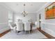 Formal dining room with stylish chandelier and classic wainscoting at 4004 Charrwood Trce, Marietta, GA 30062