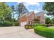 Brick home with a spacious driveway, two-car garage, and meticulously maintained landscaping at 4004 Charrwood Trce, Marietta, GA 30062