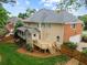 Back exterior featuring a deck, covered porch, brick accents, and a two-car garage at 4004 Charrwood Trce, Marietta, GA 30062