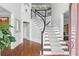 Elegant foyer with hardwood floors, staircase, and decorative millwork at 4004 Charrwood Trce, Marietta, GA 30062