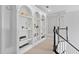 Hallway with built-in white bookshelves, neutral paint, and railing overlooking the staircase at 4004 Charrwood Trce, Marietta, GA 30062