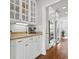 Butler's pantry with glass-front cabinets, granite countertops, and stainless steel appliances at 4004 Charrwood Trce, Marietta, GA 30062