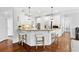 Bright kitchen featuring white cabinets, stainless steel appliances, and a breakfast bar with stool seating at 4004 Charrwood Trce, Marietta, GA 30062