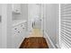Hallway with white cabinets leading to a laundry room with a washer and dryer at 4004 Charrwood Trce, Marietta, GA 30062