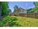 Spacious backyard featuring a well-maintained lawn and a wooden fence at 6645 N Glen Dr, Cumming, GA 30028