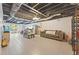 Finished basement with tiled floor, bar, sofa and a TV at 6645 N Glen Dr, Cumming, GA 30028