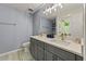 Elegant bathroom featuring a double vanity with quartz countertop and modern lighting at 6645 N Glen Dr, Cumming, GA 30028