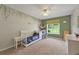 Bedroom with white crib, neutral carpet and walls with vine art at 6645 N Glen Dr, Cumming, GA 30028