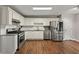 Modern kitchen featuring stainless steel appliances, granite countertops, white cabinets, and subway tile backsplash at 6645 N Glen Dr, Cumming, GA 30028