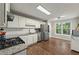 Modern kitchen featuring stainless steel appliances, granite countertops, white cabinets, and subway tile backsplash at 6645 N Glen Dr, Cumming, GA 30028