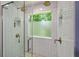 Shower with double shower heads and a window to the outside at 6645 N Glen Dr, Cumming, GA 30028