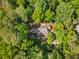 A top-down view of a well-kept residence with a lush tree canopy and mature trees at 1920 Jett Ridge Rd, Cumming, GA 30041