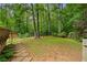 A spacious backyard featuring a stone path and lush green trees and vegetation at 1920 Jett Ridge Rd, Cumming, GA 30041