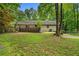 Spacious backyard with a manicured lawn and a wooden deck perfect for entertaining at 1920 Jett Ridge Rd, Cumming, GA 30041