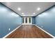 Bright basement area with new flooring, recessed lights, and double doors to the yard at 1920 Jett Ridge Rd, Cumming, GA 30041