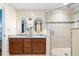 Bathroom with granite countertop vanity and tiled glass shower at 1920 Jett Ridge Rd, Cumming, GA 30041