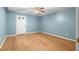 A bedroom with a wooden floor, ceiling fan, and a door leading to the outside at 1920 Jett Ridge Rd, Cumming, GA 30041