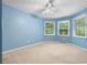 Bedroom with carpet, light blue walls, two windows, and ceiling fan at 1920 Jett Ridge Rd, Cumming, GA 30041