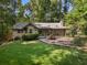 Charming single story home with a well maintained lawn, mature trees, and shrubbery at 1920 Jett Ridge Rd, Cumming, GA 30041