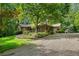 View of the landscaped front yard, gravel driveway, and charming exterior of the home at 1920 Jett Ridge Rd, Cumming, GA 30041
