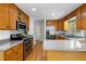 Spacious kitchen features stainless steel appliances, ample wood cabinetry, and sleek countertops at 1920 Jett Ridge Rd, Cumming, GA 30041