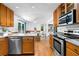 Bright kitchen with stainless appliances, light wood cabinets, and a view of the dining area at 1920 Jett Ridge Rd, Cumming, GA 30041