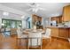 Bright kitchen with a sunroom, stainless steel appliances, granite countertops, and hardwood floors at 1920 Jett Ridge Rd, Cumming, GA 30041
